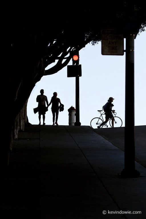 A couple, a man and a bicycle